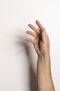 Cropped hand gesturing against white background