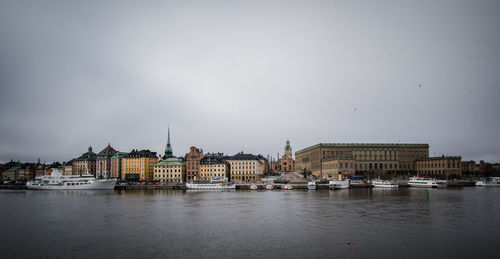 Boats in river with buildings in background