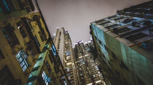 Low angle view of skyscrapers against sky at night