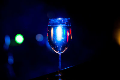 Close-up of wine glass against black background