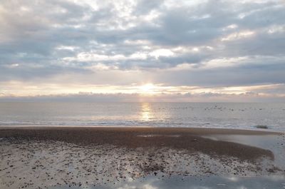 Scenic view of beach against sky during sunset