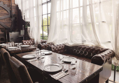 Close-up of chairs on table