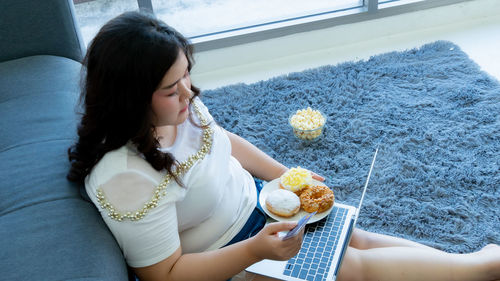 Midsection of woman holding ice cream