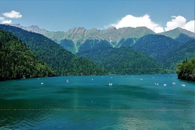 Scenic view of lake and mountains against sky