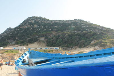 Scenic view of beach against clear blue sky