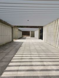 Empty footpath amidst buildings in city