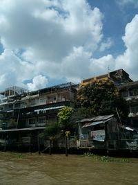 Buildings against cloudy sky