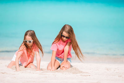 Low angle view of women on beach