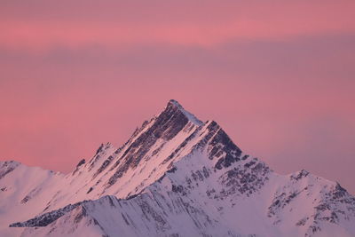 Snow covered mountain against sky during sunset