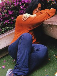 Portrait of young woman sitting at park