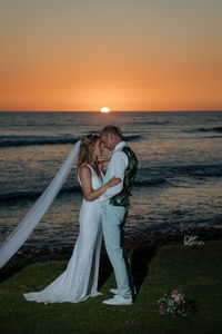 Couple on beach during sunset