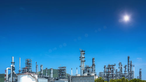 Low angle view of factory against blue sky