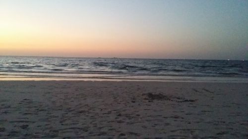 Scenic view of beach against sky during sunset