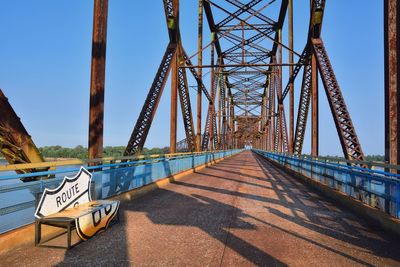 Low angle view of bridge against sky on sunny day