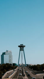 Low angle view of cityscape against clear blue sky