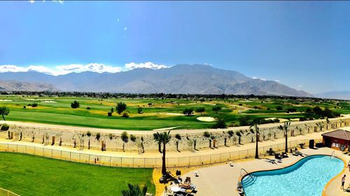 Scenic view of golf course against sky