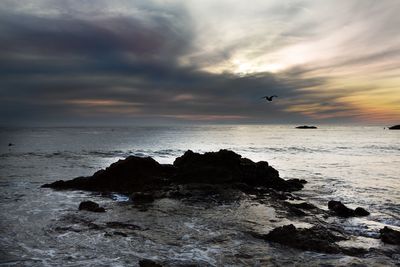 Scenic view of sea against cloudy sky