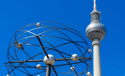 Low angle view of communications tower against blue sky