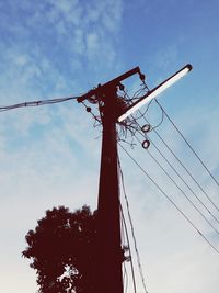 Low angle view of electricity pylon against sky