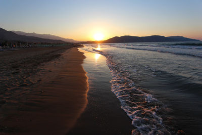 Scenic view of beach against sky during sunset