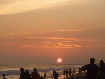 People on beach at sunset