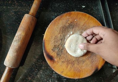 High angle view of person preparing indian chapati bread.