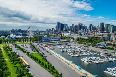 High angle view of city buildings against cloudy sky