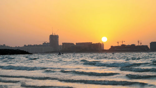 Dubai, united arab emirates, uae -  at sunset, the surf. waves roll on the sand
