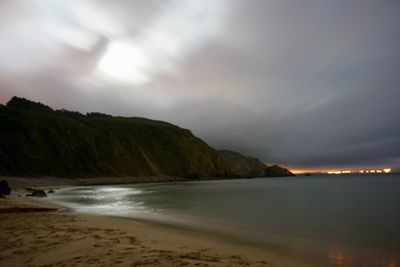 Scenic view of sea and mountains against sky