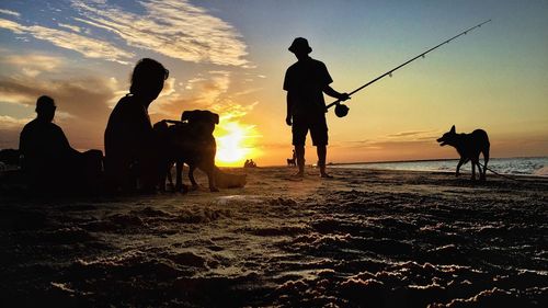 Silhouette people at sunset