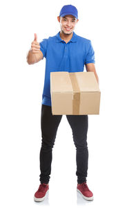 Full length of smiling man standing against white background