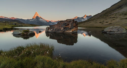 Scenic view of lake and mountains against sky