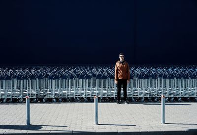 Man standing against shopping carts