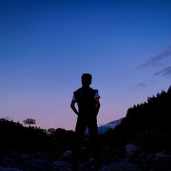 Silhouette man standing against sky during sunset