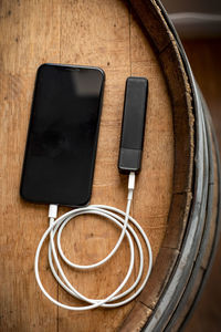 A smartphone charges with a usb battery pack.