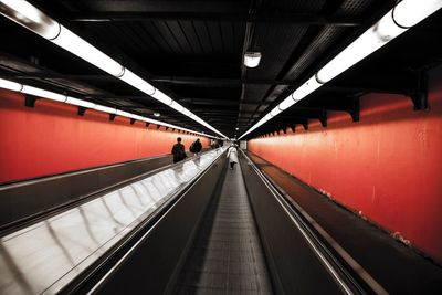 People on moving walkway in subway station