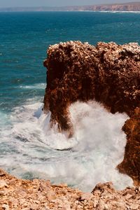 Scenic view of rocks on sea shore