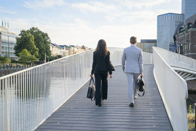 Business people walking through footbridge