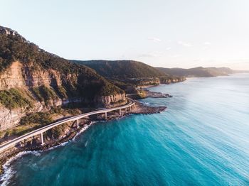 High angle view of rocky coastline against clear sky