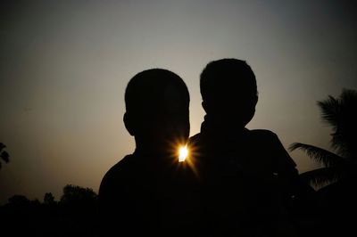 Silhouette man against sky during sunset