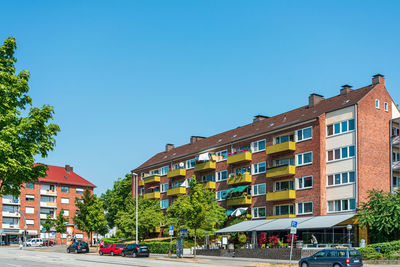 View of residential buildings against clear sky