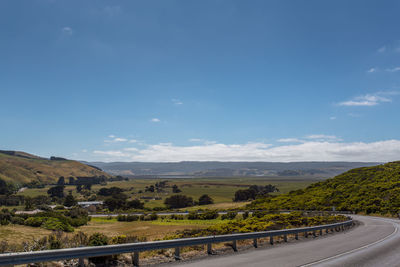 Road leading towards mountain against sky