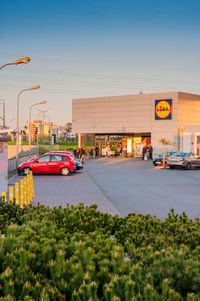 Cars on road against sky in city