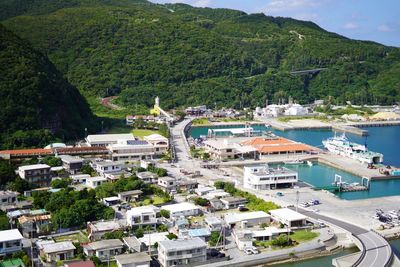 High angle view of buildings and trees by sea