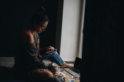 Woman using mobile phone at home