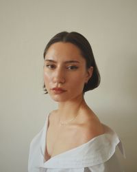 Portrait of a young woman against white background