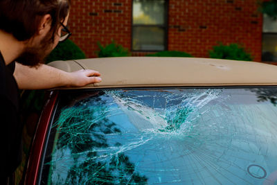 Woman hand holding glass of car