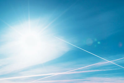 Low angle view of vapor trail in blue sky