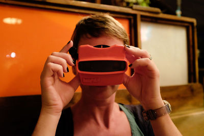 Close-up of boy playing using mobile phone