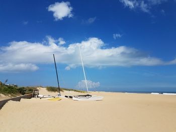 Sailboats on beach against sky